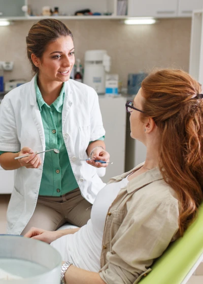 Dentist talking to woman
